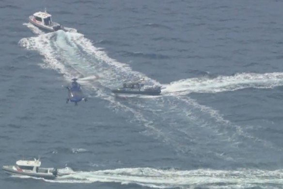Emergency services use boats and helicopters to search Port Phillip Bay on Sunday afternoon.