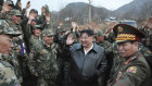 Korean leader Kim Jong-un is surrounded by soldiers during a visit to his top tank unit.