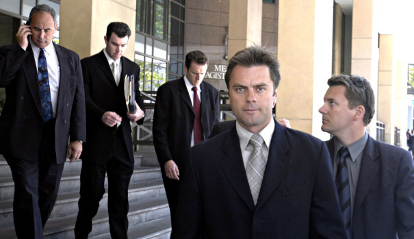 Then-Senior Sergeant Stuart Bateson leads members of the Purana taskforce away from Melbourne Magistrates Court in 2003.