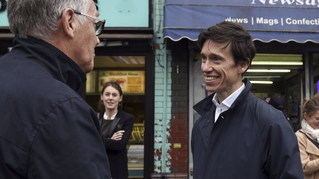 Rory Stewart, right, a candidate for prime minister, campaigns in Wigan, England.