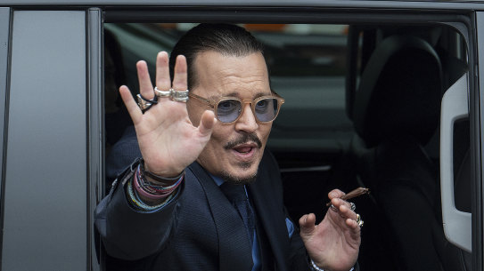 On a typical day of the trial: Johnny Depp waves to supporters as he departs Fairfax County Courthouse on May 27.