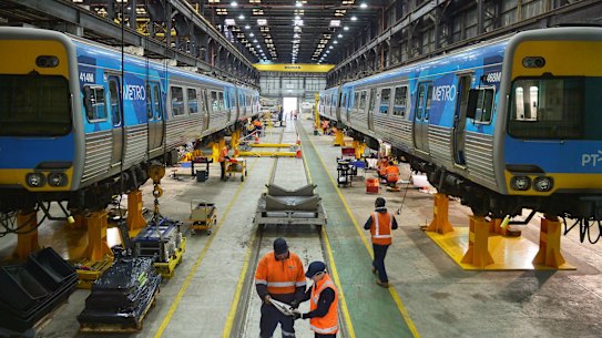 Workers at Downer's Newport workshop, where high-capacity trains will be built.  