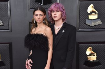 Katarina Deme, left, and The Kid Laroi arrive at the 64th Annual Grammy Awards.