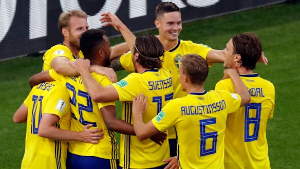 On top: Sweden players celebrate after the third goal. 