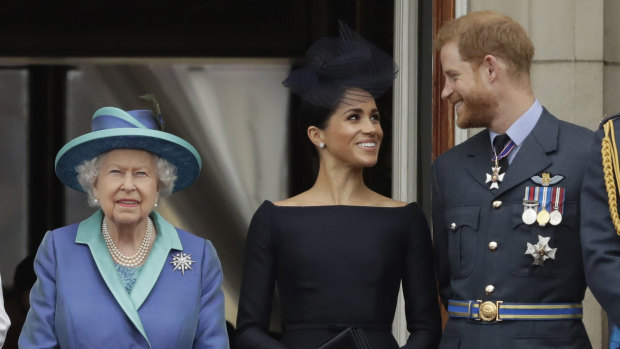 The late Queen with the Duke and Duchess of Sussex in 2018. 