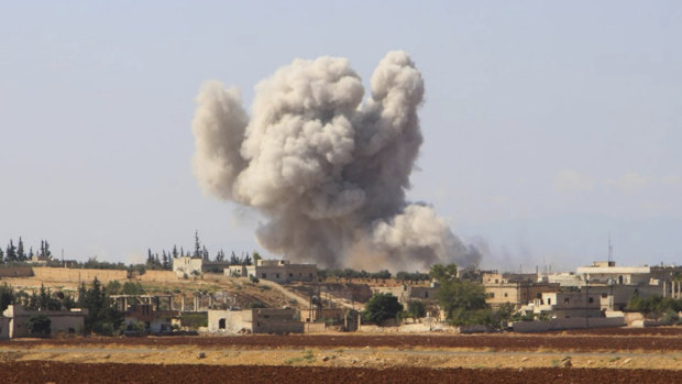 Smoke rises after a Syrian government airstrike, in Hobeit village, near Idlib, Syria.