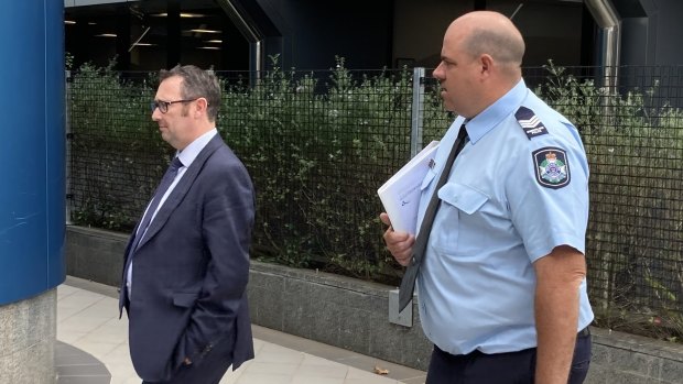 Sergeant Dan Curtain (right) leaves Toowoomba Magistrates Court on Thursday morning.