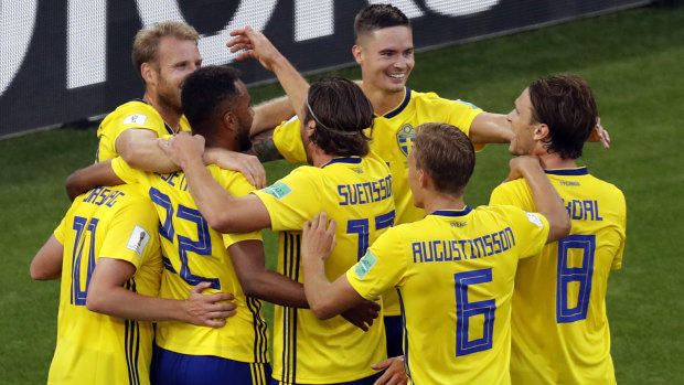 On top: Sweden players celebrate after the third goal. 