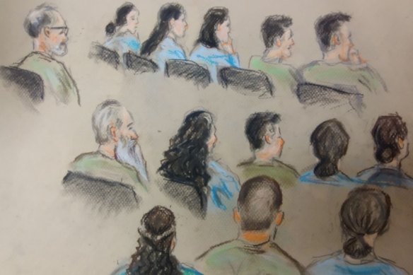 The 14 defendants in the trial over the death of Elizabeth Struhs, all members of a fringe religious group, appear in a Brisbane court.