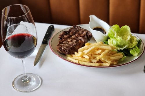 Steak frites is served with either bordelaise or bearnaise sauce and salad at Normandy Wine and Grill.