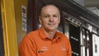 Aurizon’s Andrew Harding with “BEL”, the protoype diesel locomotive that his engineers have started stripping and rebuilding as an electric and battery-powered loco. 