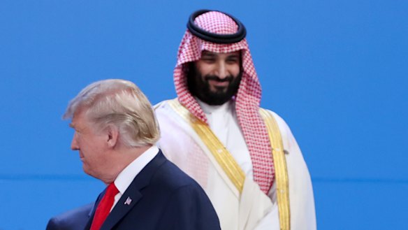 Saudi Arabia's Crown Prince Mohammed bin Salman, back, stands as President Donald Trump passes by at the G20 in Buenos Aires.