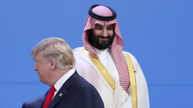 Saudi Arabia's Crown Prince Mohammed bin Salman, back, stands as President Donald Trump passes by at the G20 in Buenos Aires.