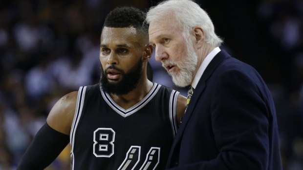 San Antonio coach Gregg Popovich with Patty Mills.