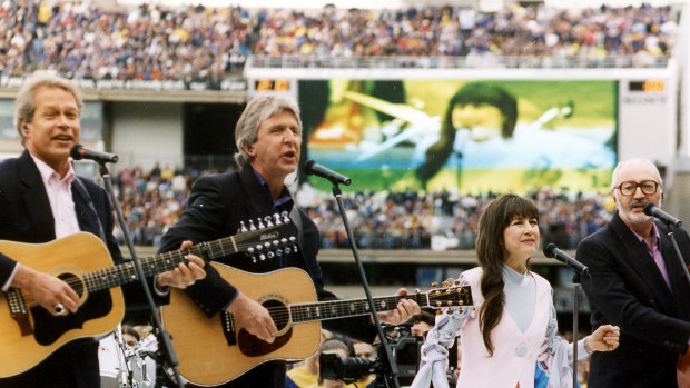 The Seekers - Keith Potger , Bruce Woodley, Judith Durham and Athol Guy - performing at the 1994 AFL Grand Final at the MCG.