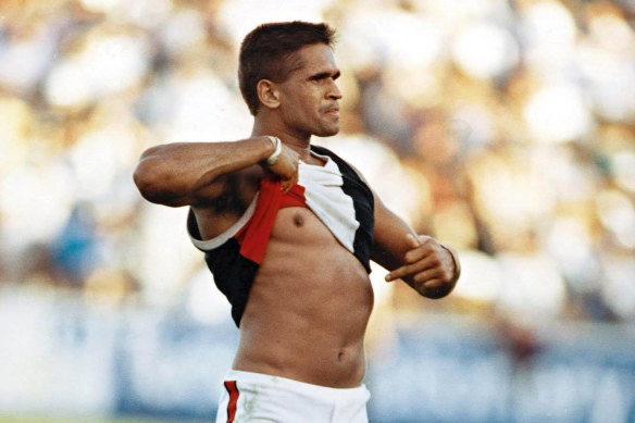 St Kilda player Nicky Winmar points to his skin in response to a racist taunt from the crowd in 1993.