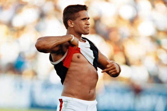 St Kilda player Nicky Winmar points to his skin in response to a racist taunt from the crowd in 1993.