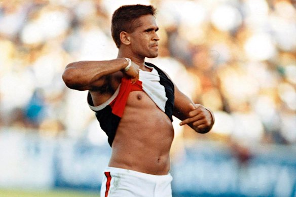St Kilda player Nicky Winmar points to his skin in response to racist taunts from the crowd in 1993.