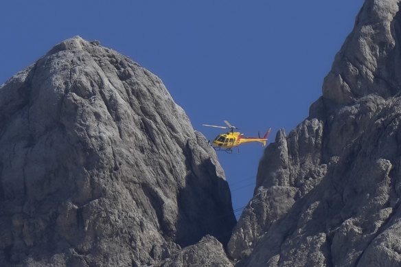 A rescue helicopter hovers over the Punta Rocca glacier near Canazei in the Italian Alps on Monday.