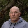 Lismore mayor Steve Krieg standing near a flooded Wilsons River on March 11, 2025.