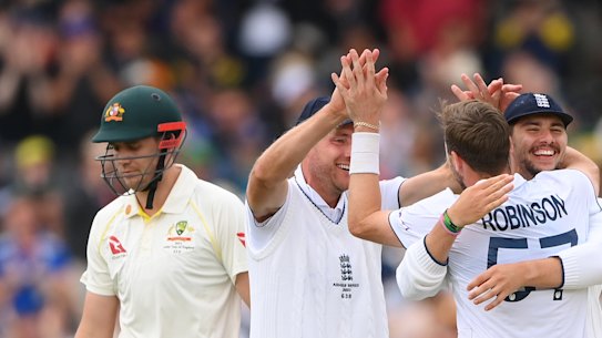 Ollie Robinson of England celebrates with teammates Stuart Broad and Josh Tongue after dismissing Cameron Green in the 2023 Ashes. 