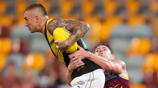 Dustin Martin is tackled by Lachie Neale.