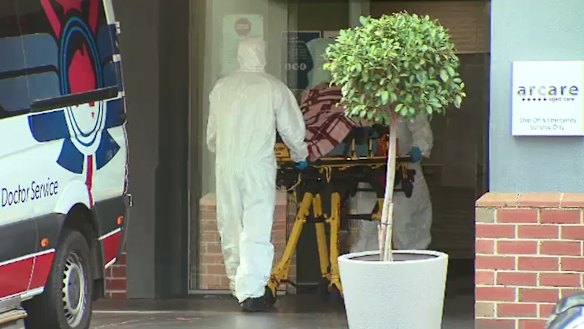 A COVID-positive resident is removed from Arcare’s Maidstone home on Sunday.