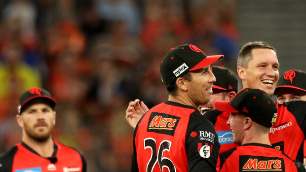 Chris Tremain (centre) of the Renegades celebrates with teammates after bowling Cameron Bancroft.