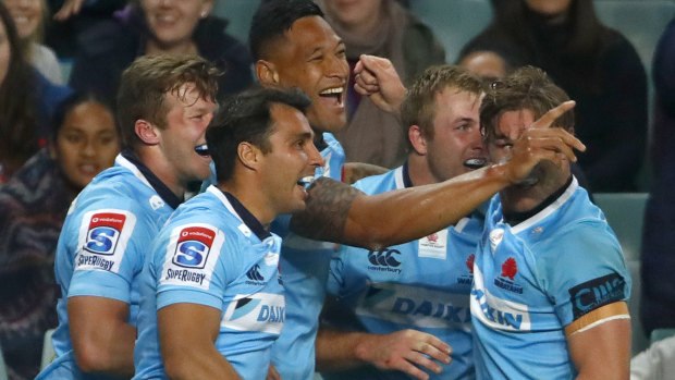 Drought-breaker: The Tahs celebrate on their way to the first Australian win over a New Zealand team in 722 days.