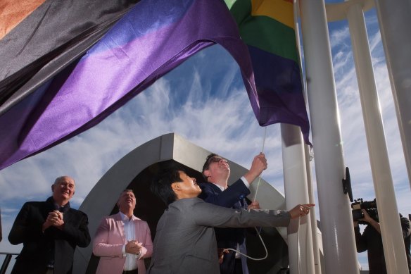 Premier Daniel Andrews and Hang Vo, chair of the Victorian pride centre, raise the flag at the Victorian Pride Centre in St Kilda.