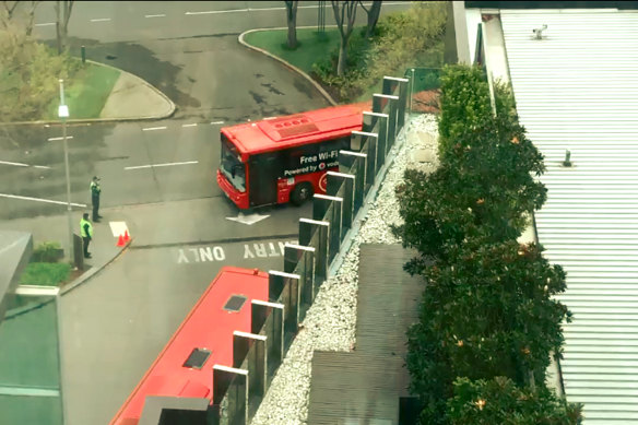 A SkyBus arrives at Crown Promenade on Thursday. The buses carried returned overseas travellers beginning their mandatory 14-day hotel stay.