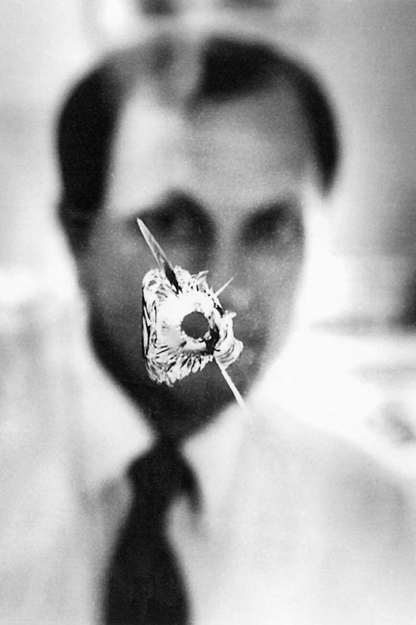John Newman in his electoral office in 1991 after a bullet was fired through its window.
