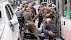 Ukrainian servicemen carry a body from a trolleybus after a Russian missile strike on Sumy, Ukraine.