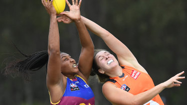 Top marks: Sabrina Frederick-Traub of the Lions (left) takes a grab under pressure from Erin McKinnon.