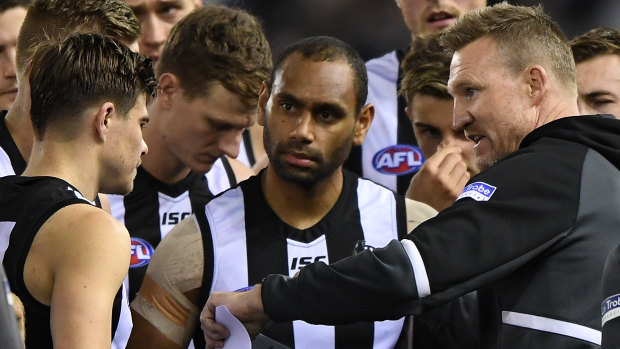 Buck up your ideas: Collingwood coach (right) gets his message across during a break in the match against North Melbourne on Saturday night.