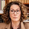 Kitty Flanagan as the brown-suited probate lawyer Helen Tudor-Fisk.
