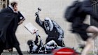 Undated photo released by Banksy of the new artwork by the artist which portrays a judge beating a protester with a gavel at the Royal Courts of Justice in London. (Banksy via AP)