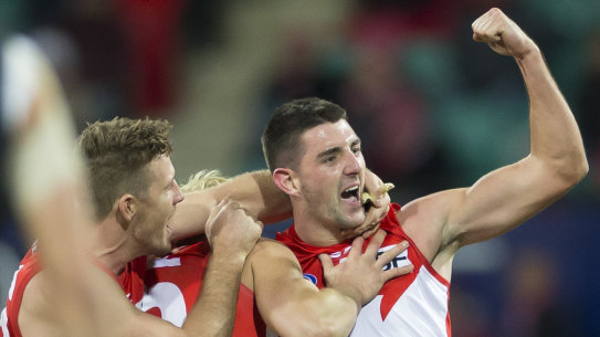 Cheer, cheer: The Swans celebrate Colin O’Riordan’s first AFL goal during a drought-breaking win on Friday night.