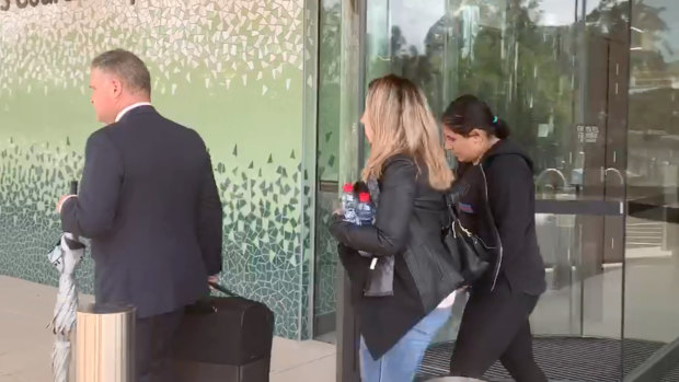 Camila Zeidan, right, leaves the inquest at Lidcombe Coroners Court on Monday.
