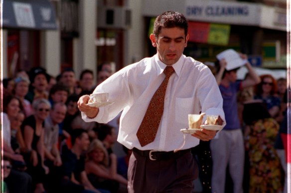 A Marios waiter spills a drop or two during the Waiters Race at Melbourne Fringe Street Parade and Party, 1998.