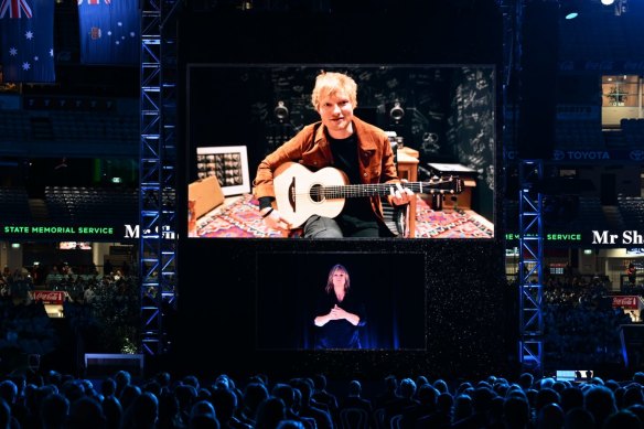 Ed Sheeran’s recorded performance is played at the state memorial service for Shane Warne at the MCG on March 30.