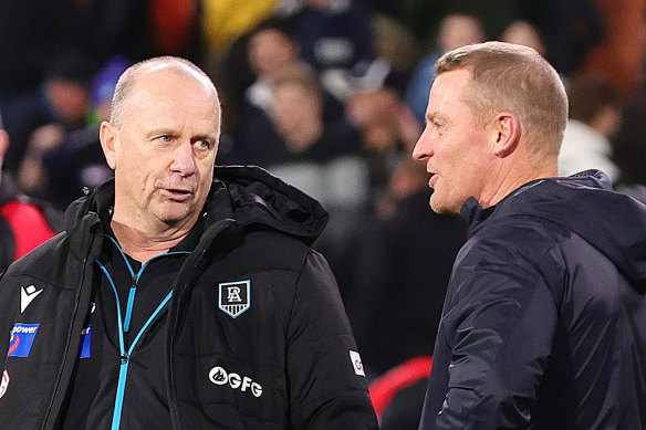 Port coach Ken Hinkley and his former assistant Michael Voss, now in charge of Carlton, compare notes post-game.