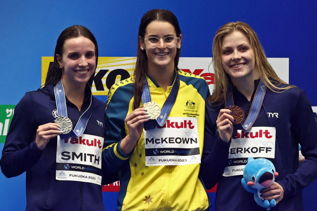 Australian Kaylee McKeown (centre) after her 100m backstroke victory over American Regan Smith (left) at the 2023 world swimming championships.