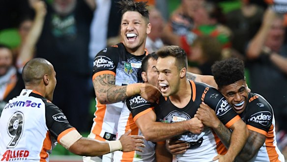Penalties are up - and so are the wins: Tigers players celebrate victory over the Storm.