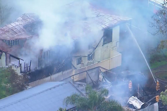 Fire crews battle the large blaze that has engulfed multiple homes on Russell Island off Brisbane.