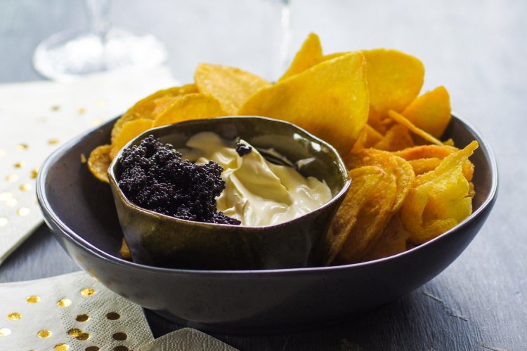 Kettle chips with champagne creme fraiche and caviar. Christmas canape recipes for Good Food online feature December 2018. Please credit Katrina Meynink.