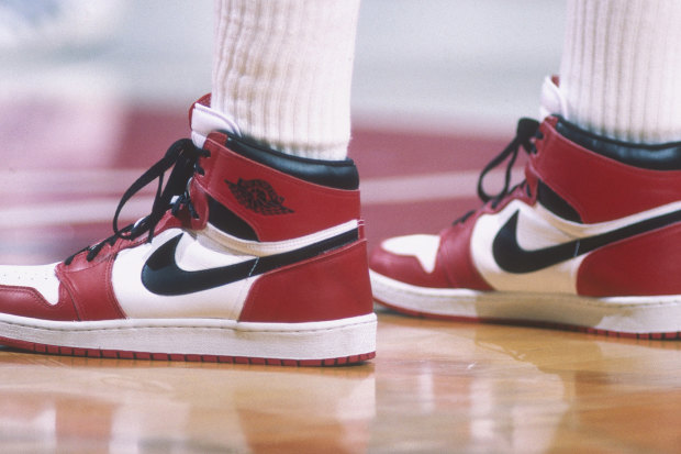 Michael Jordan dons a pair of Air Jordan 1s during a 1985 NBA match against the Bullets in Washington.