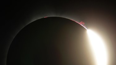 This photo shows solar flare as the sun emerges from a total eclipse by the moon.