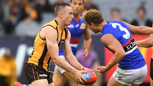 Taking flight: Tom Scully back in action, on his debut for the Hawks against the Bulldogs.