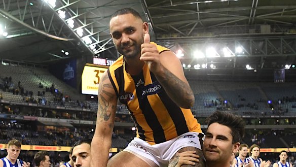 Burgoyne is chaired from the ground after breaking the Indigenous player games record. 